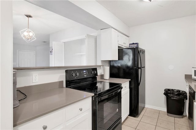 kitchen featuring decorative light fixtures, white cabinetry, light tile patterned floors, black appliances, and an inviting chandelier