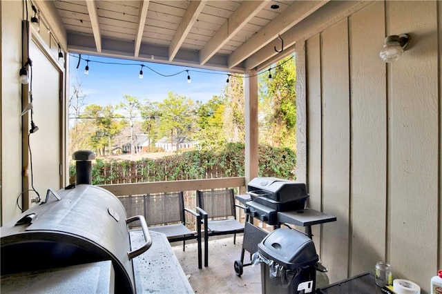 sunroom featuring beamed ceiling