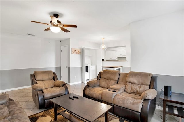 living room with light tile patterned floors and ceiling fan