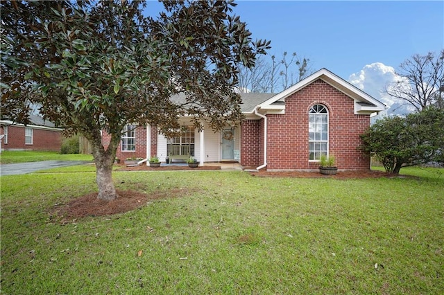 ranch-style home with a front yard and brick siding