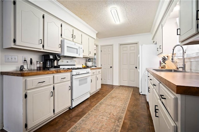 kitchen featuring ornamental molding, white appliances, white cabinetry, and a sink