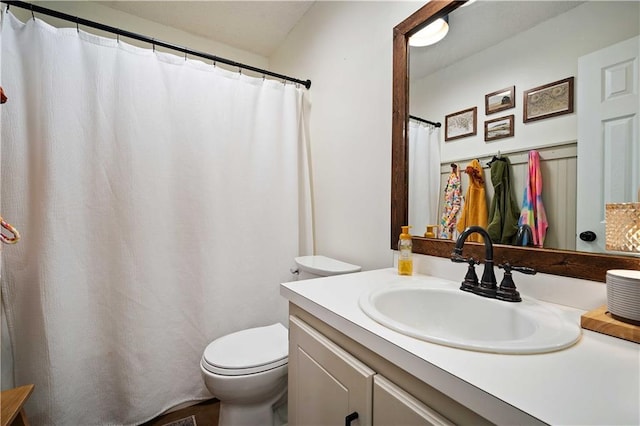 bathroom featuring toilet and vanity