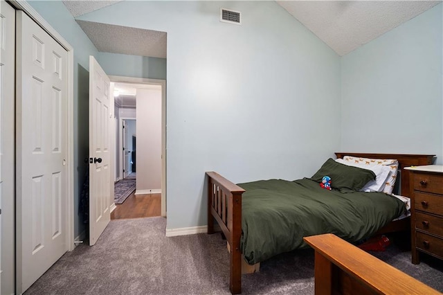 carpeted bedroom with baseboards, visible vents, a textured ceiling, and lofted ceiling