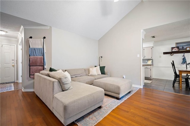 living room with baseboards, lofted ceiling, dark wood-style floors, and crown molding