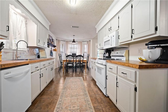 kitchen featuring a sink, white appliances, butcher block countertops, and white cabinetry