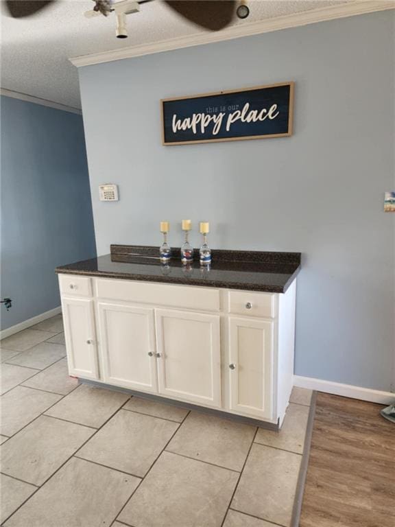 829 Desoto Dr, Dauphin Island, AL 36528 - indoor dry bar featuring ornamental molding, light tile patterned floors, a textured ceiling, and baseboards