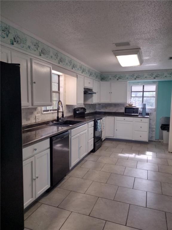 829 Desoto Dr, Dauphin Island, AL 36528 - kitchen with black appliances, a sink, white cabinetry, dark countertops, and a textured ceiling