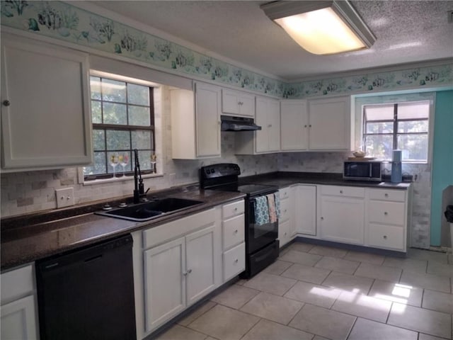 829 Desoto Dr, Dauphin Island, AL 36528 - kitchen with black appliances, under cabinet range hood, a sink, and white cabinetry