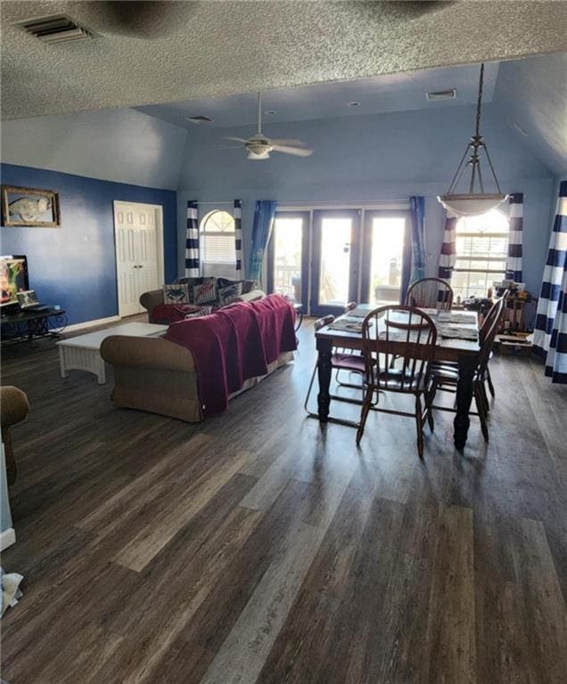 829 Desoto Dr, Dauphin Island, AL 36528 - dining room featuring vaulted ceiling, a textured ceiling, dark wood-type flooring, a ceiling fan, and baseboards