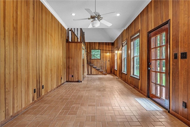 hall with wooden walls and ornamental molding