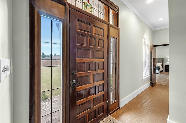 foyer featuring ornamental molding