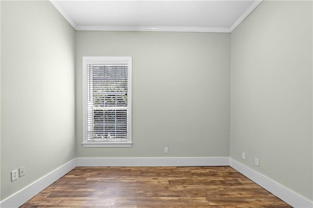 empty room featuring ornamental molding and hardwood / wood-style flooring