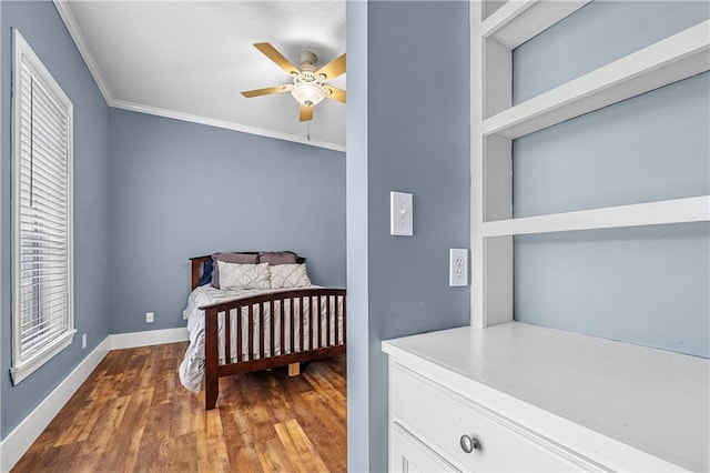 bedroom featuring ceiling fan, ornamental molding, and wood-type flooring