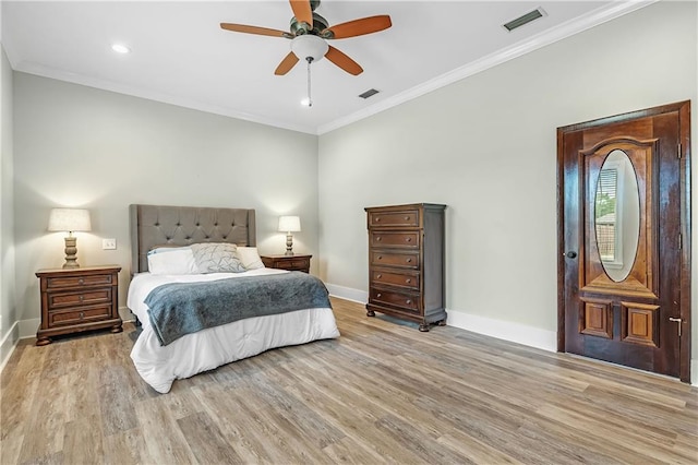 bedroom featuring ceiling fan, light hardwood / wood-style flooring, and crown molding