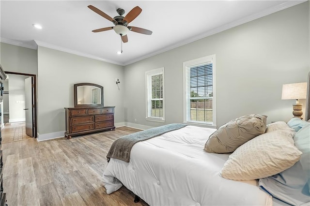 bedroom with ceiling fan, light wood-type flooring, and ornamental molding