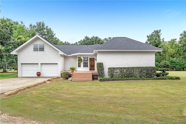 view of front of property featuring a front yard and a garage