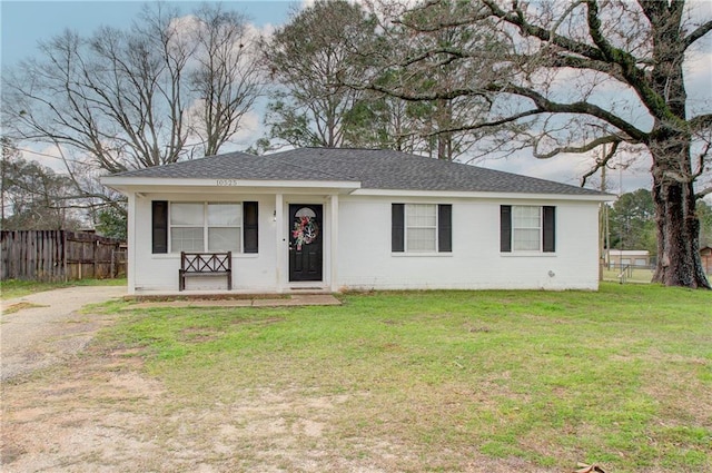 single story home with driveway, a shingled roof, a front yard, and fence