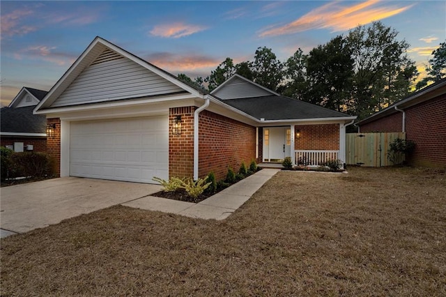 ranch-style house with a yard and a garage