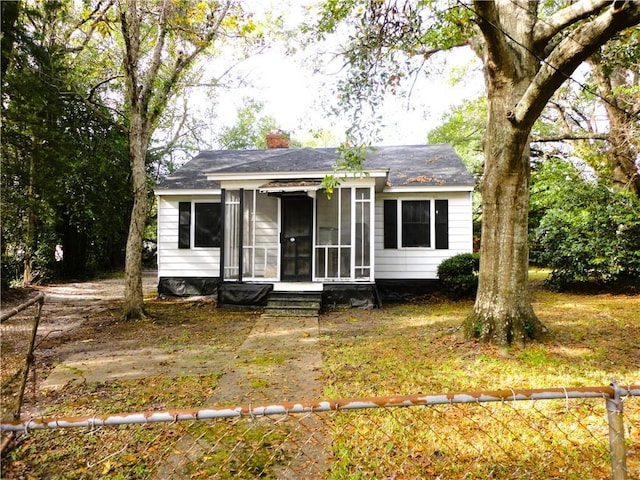 view of front of home featuring a sunroom