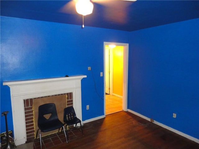 interior space featuring dark hardwood / wood-style floors and a brick fireplace