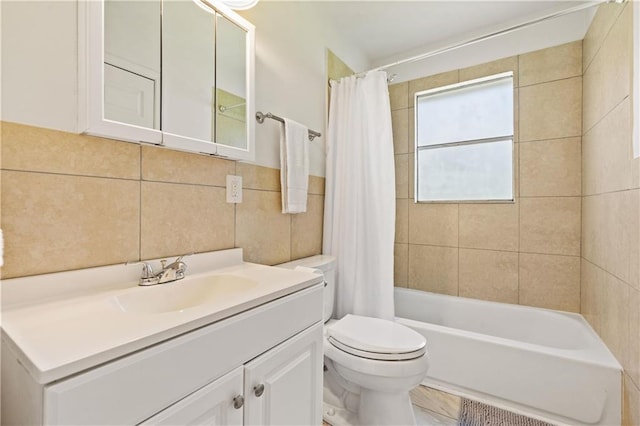 bathroom with shower / bath combination with curtain, toilet, tile walls, and vanity