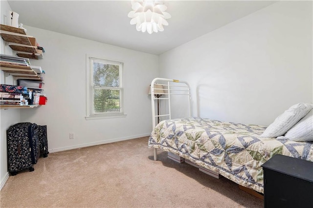 bedroom with a chandelier, light carpet, and baseboards