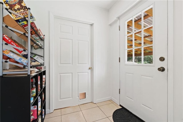 doorway to outside featuring light tile patterned flooring