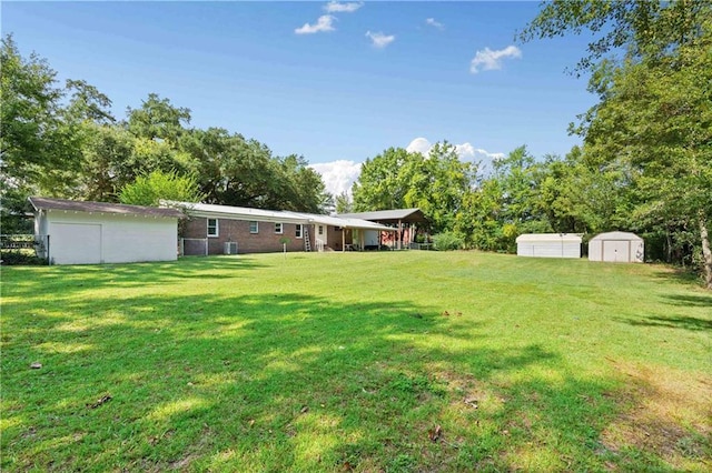 view of yard featuring a storage unit and an outdoor structure