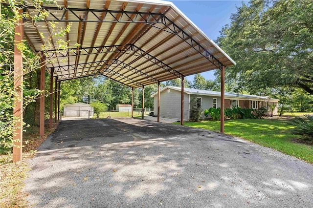 view of parking / parking lot with driveway and a detached carport