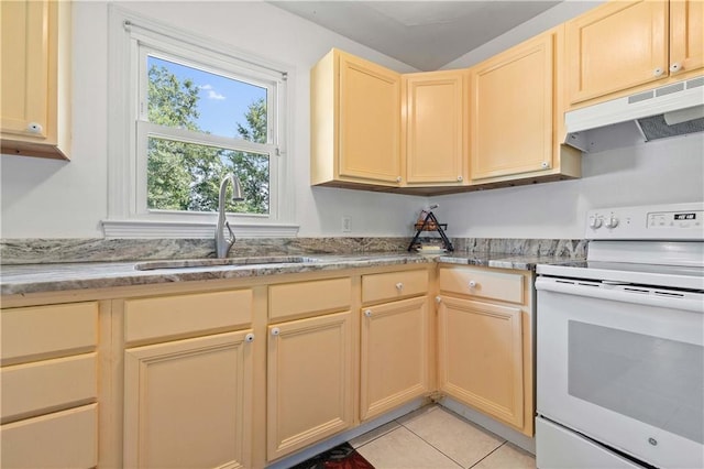 kitchen with white range with electric stovetop, light tile patterned floors, light brown cabinetry, a sink, and under cabinet range hood