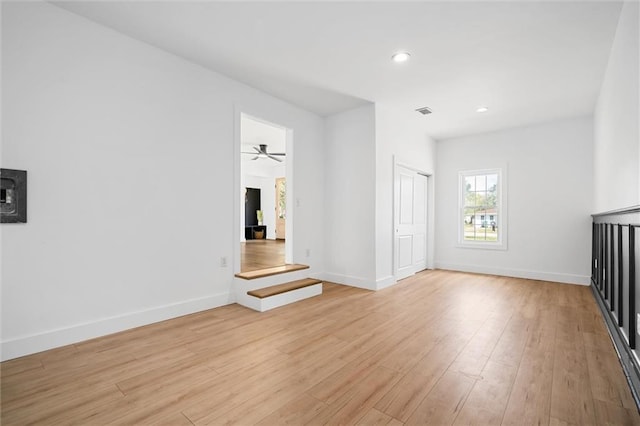 unfurnished living room with ceiling fan and light hardwood / wood-style floors