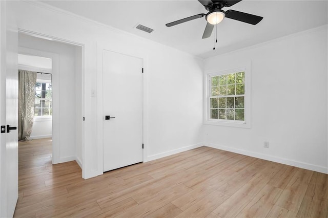 unfurnished room with crown molding, ceiling fan, and light hardwood / wood-style floors