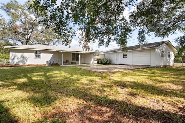 back of property with a lawn and central air condition unit