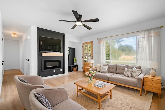 living room with ceiling fan and light hardwood / wood-style floors