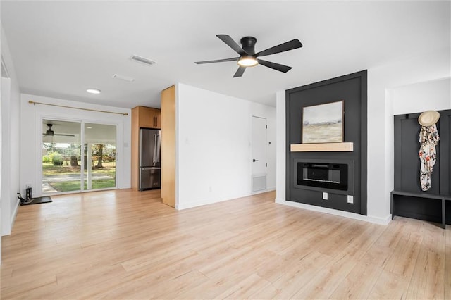 unfurnished living room featuring light wood-type flooring and ceiling fan