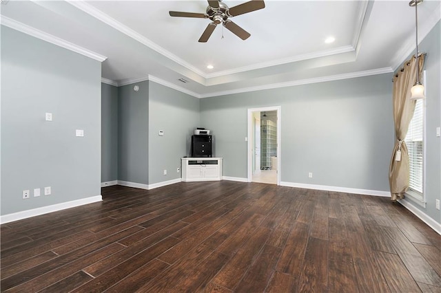 unfurnished living room featuring dark hardwood / wood-style floors, a raised ceiling, ceiling fan, and ornamental molding