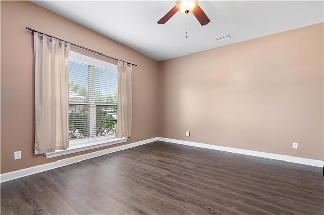 empty room with dark wood-type flooring and ceiling fan