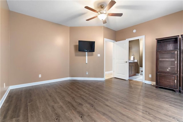 unfurnished bedroom with ensuite bath, ceiling fan, dark hardwood / wood-style flooring, and lofted ceiling