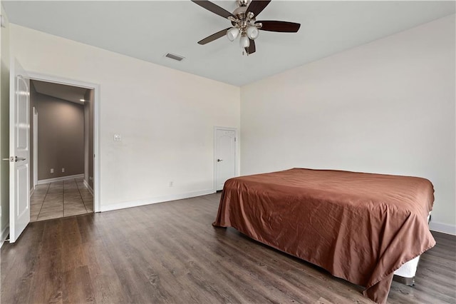 bedroom featuring ceiling fan and dark tile floors