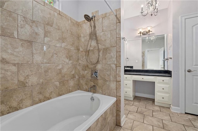 bathroom featuring tiled shower / bath, vanity, tile floors, and an inviting chandelier