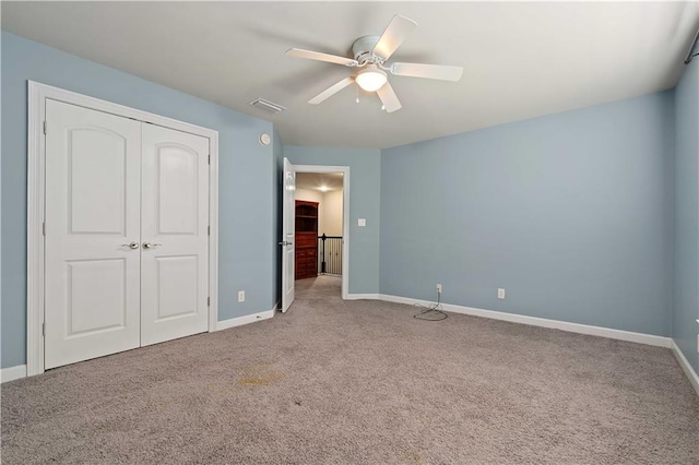 unfurnished bedroom featuring a closet, ceiling fan, and carpet flooring