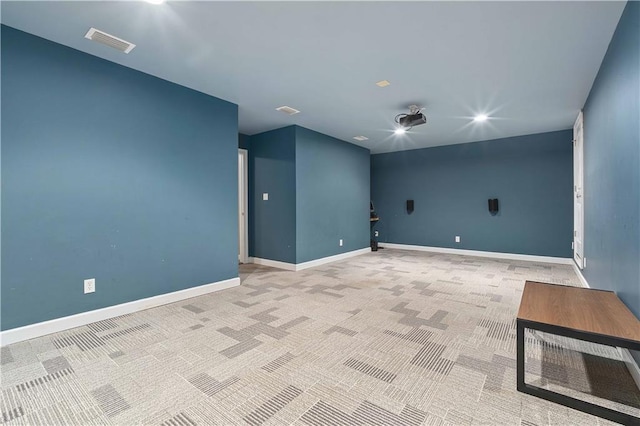 unfurnished room featuring light carpet