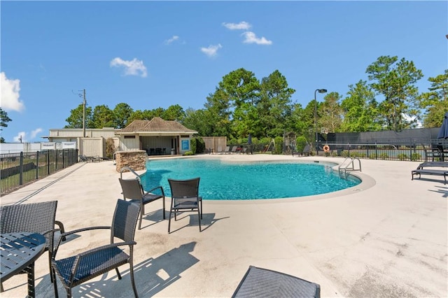 view of swimming pool with a patio