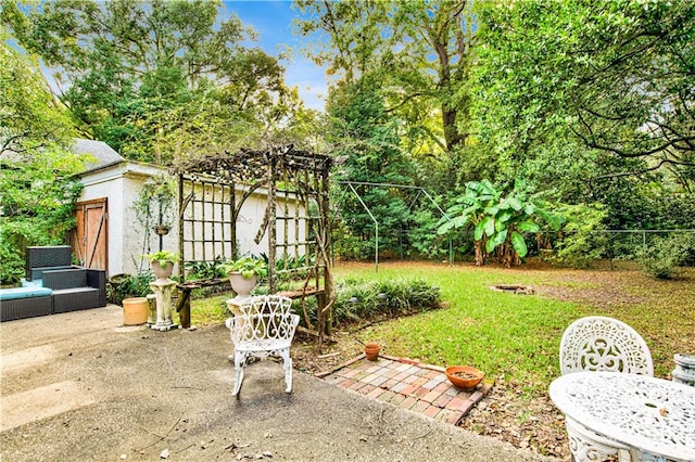 view of yard with an outbuilding and a patio