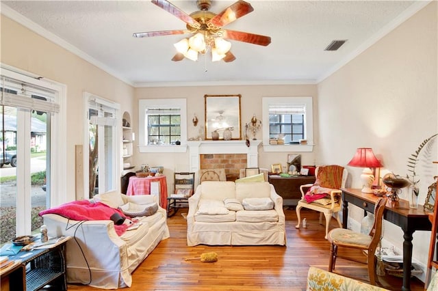 sitting room featuring hardwood / wood-style flooring, a healthy amount of sunlight, and ornamental molding