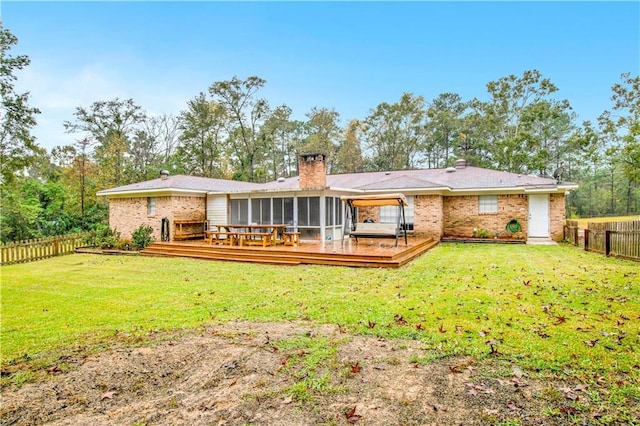 back of house with a sunroom, a yard, and a wooden deck