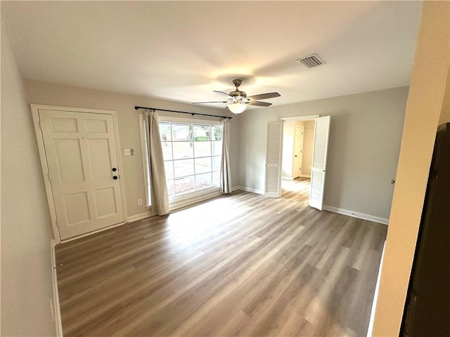 spare room featuring hardwood / wood-style floors and ceiling fan