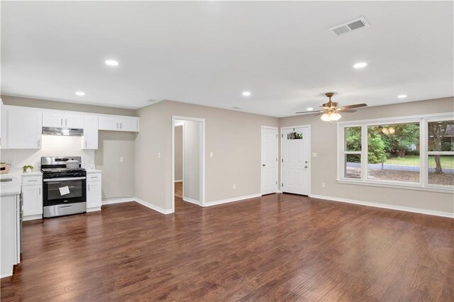 113 Hilltop Dr E, Mobile, AL 36608 - kitchen with stainless steel gas stove, under cabinet range hood, light countertops, dark wood-style flooring, and baseboards