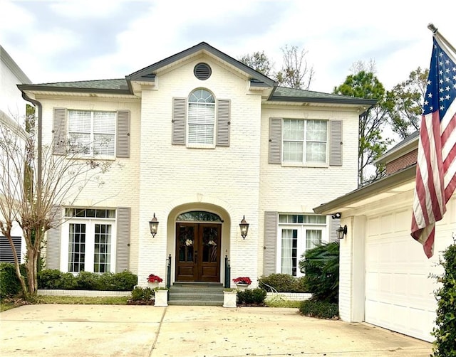 view of front of home featuring french doors and a garage