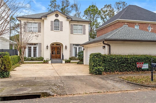 front facade featuring french doors and a garage